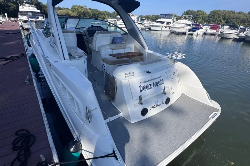 Slide: The Image of 2008 Sea Ray 350 Sundancer docked at marina, rear view with seating area. - 6