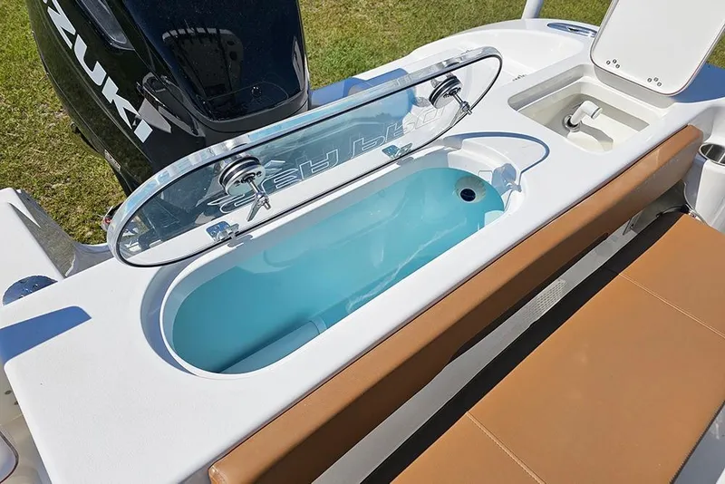Slide: The Image of 2026 Sea Pro 242 Center Console Sport boat with open livewell and Suzuki engine. - 14