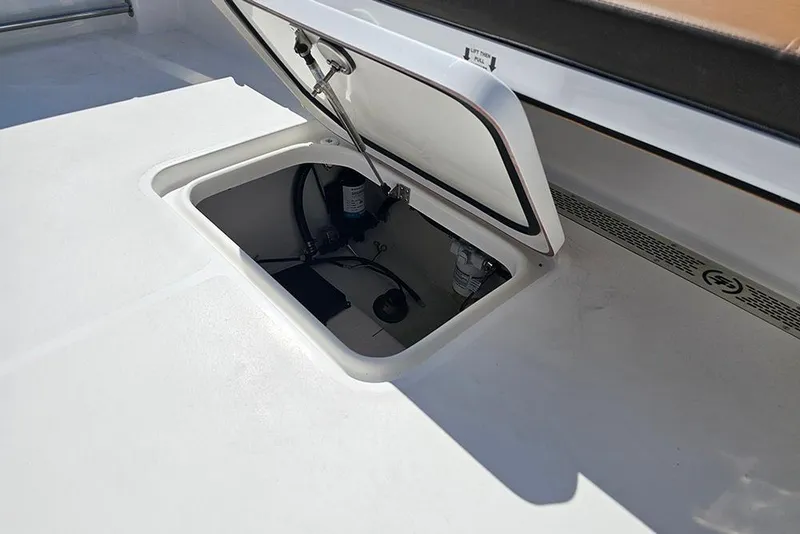 Slide: The Image of 2026 Sea Pro 242 Center Console Sport boat storage compartment open on deck. - 17