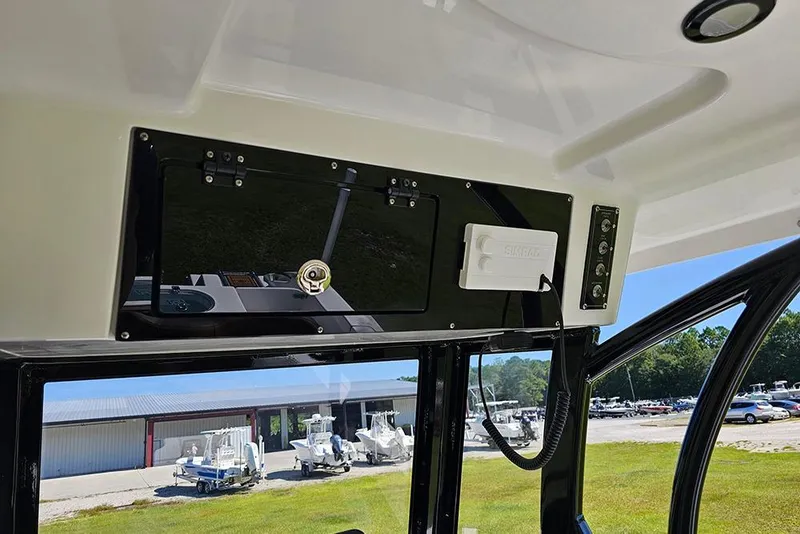 Slide: The Image of 2026 Sea Pro 242 Center Console Sport boat interior with control panel and outdoor view. - 22