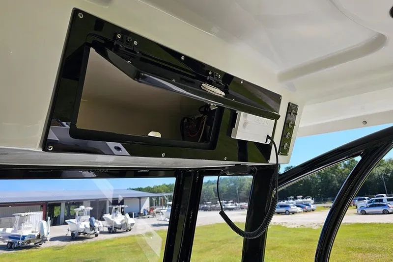 Slide: The Image of 2026 Sea Pro 242 Center Console Sport boat's overhead storage compartment open. - 23