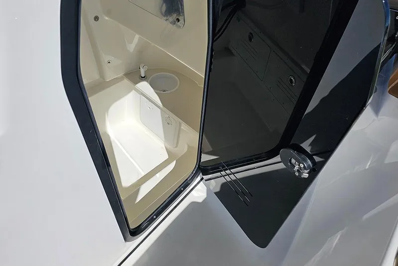 Slide: The Image of 2026 Sea Pro 242 Center Console Sport boat interior with open storage compartment. - 27