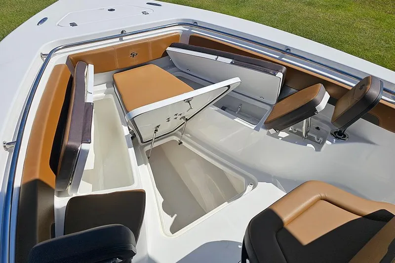 Slide: The Image of 2026 Sea Pro 242 Center Console Sport boat interior with open storage compartments and cushioned seating. - 34