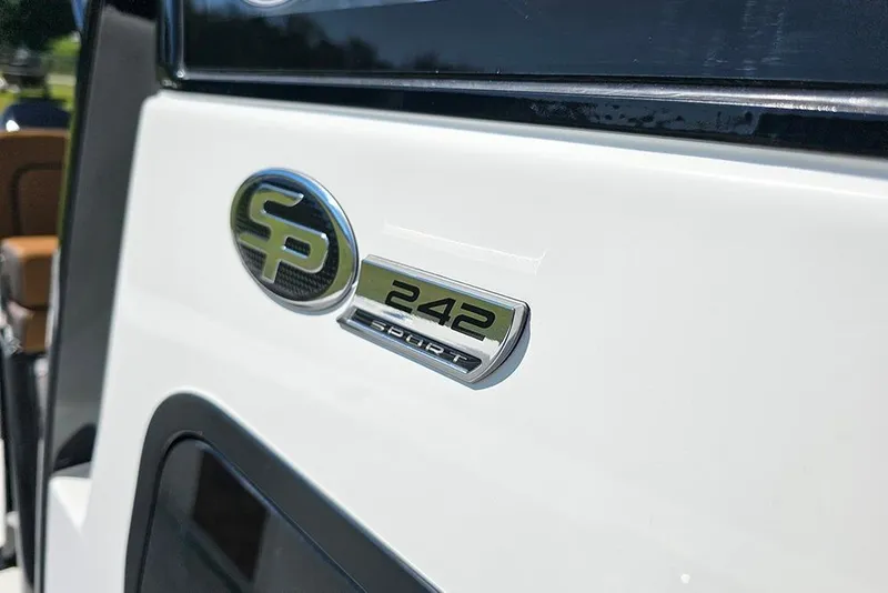 Slide: The Image of 2026 Sea Pro 242 Center Console Sport emblem on white boat exterior. - 37