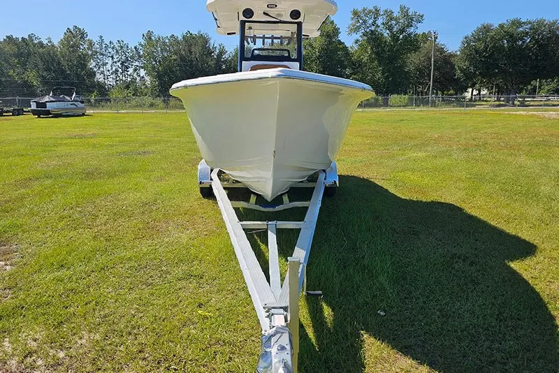 Slide: The Image of 2026 Sea Pro 242 Center Console Sport boat on trailer, parked on grassy field. - 4