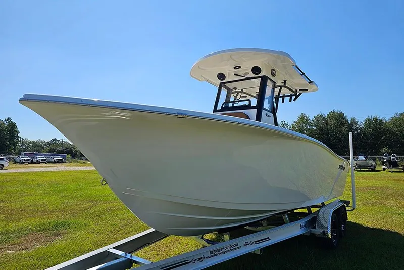 Slide: The Image of 2026 Sea Pro 242 Center Console Sport boat on trailer, displayed outdoors. - 6