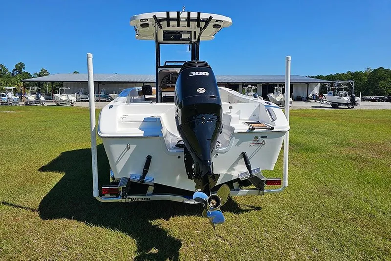 Slide: The Image of 2026 Sea Pro 242 Center Console Sport boat with powerful outboard motor on grassy area. - 9