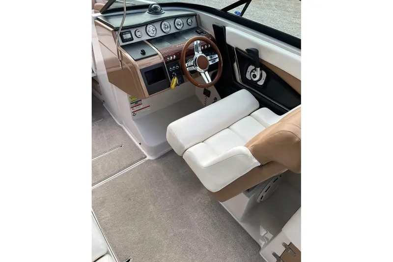 Slide: The Image of 2011 Four Winns SL262 boat interior with steering wheel and dashboard controls. - 7