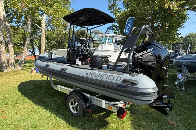 Slide: The Image of 2025 Highfield Patrol 540 boat on trailer, displayed outdoors with Mercury engine. - 4