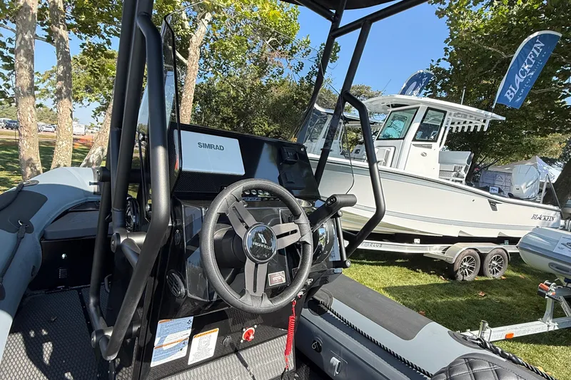 Slide: The Image of 2025 Highfield Patrol 540 boat interior with steering wheel and Simrad display. - 6