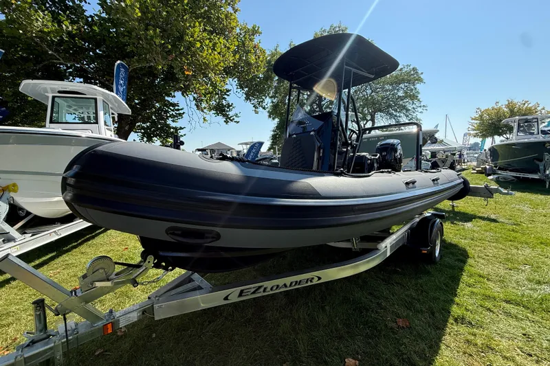 Slide: The Image of 2025 Highfield Patrol 540 boat on trailer, displayed outdoors under clear sky. - 7
