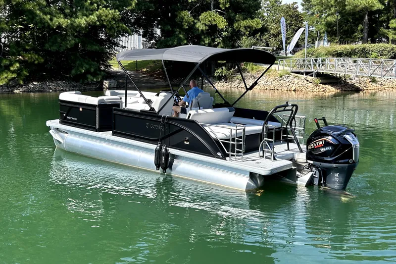 Slide: The Image of 2026 Godfrey Sweetwater 2486 SFLC pontoon boat on a serene lake. - 1