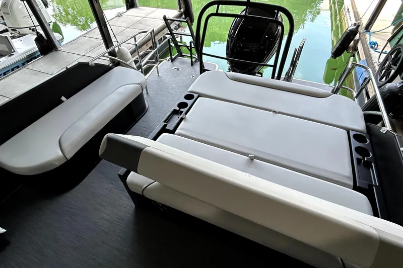 Slide: The Image of 2026 Godfrey Sweetwater 2486 SFLC boat interior with seating and water view. - 11