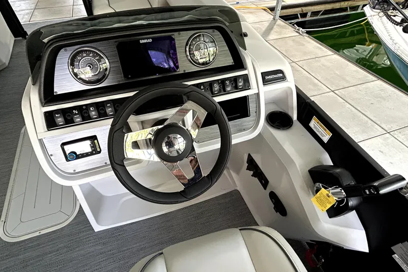 Slide: The Image of 2026 Godfrey Sweetwater 2486 SFLC boat dashboard with steering wheel and control panel. - 12