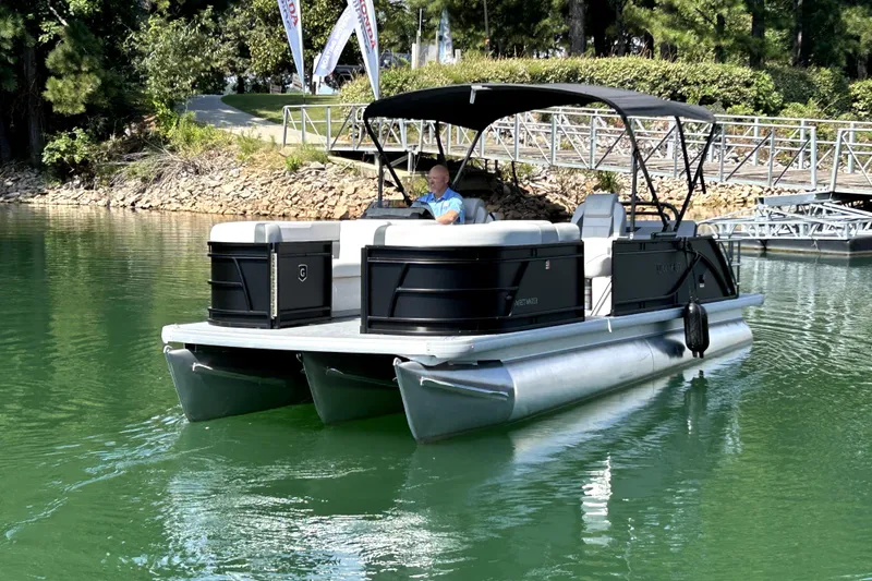 Slide: The Image of 2026 Godfrey Sweetwater 2486 SFLC pontoon boat on a serene lake. - 3