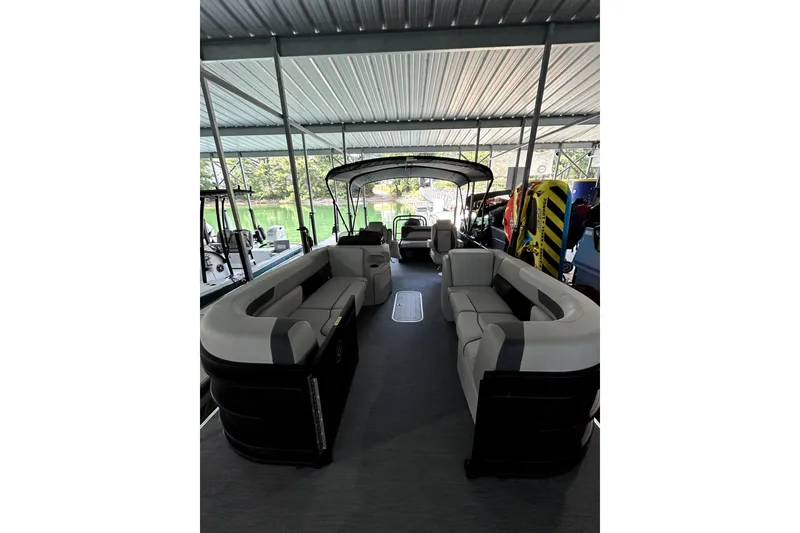 Slide: The Image of 2026 Godfrey Sweetwater 2486 SFLC pontoon boat interior with spacious seating under a canopy. - 7