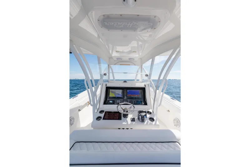 Slide: The Image of 2020 SeaHunter 33 Tournament boat cockpit with advanced navigation system on open water. - 13