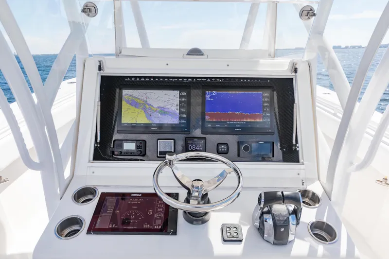 Slide: The Image of 2020 SeaHunter 33 Tournament boat dashboard with navigation screens and controls. - 16