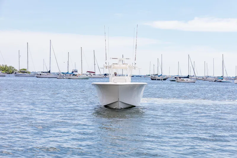 Slide: The Image of 2020 SeaHunter 33 Tournament boat cruising in a marina with sailboats. - 3