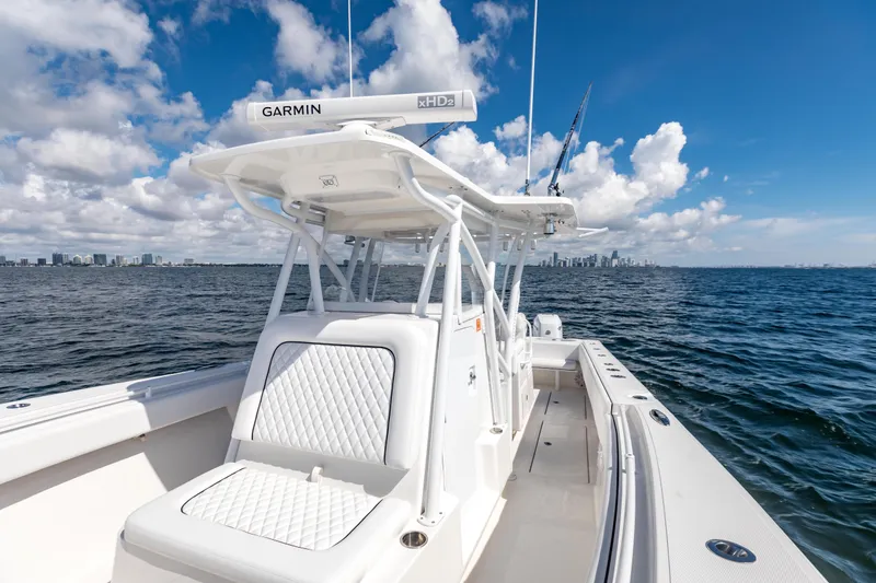 Slide: The Image of 2020 SeaHunter 33 Tournament boat on open water with city skyline in background. - 9