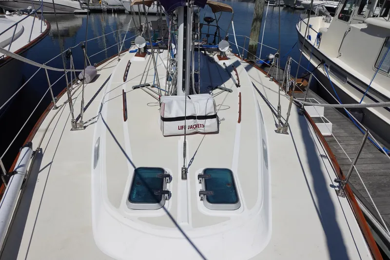 Slide: The Image of 1987 Tartan Marine Sparman Stephens 40 sailboat deck with life jackets and hatches. - 1