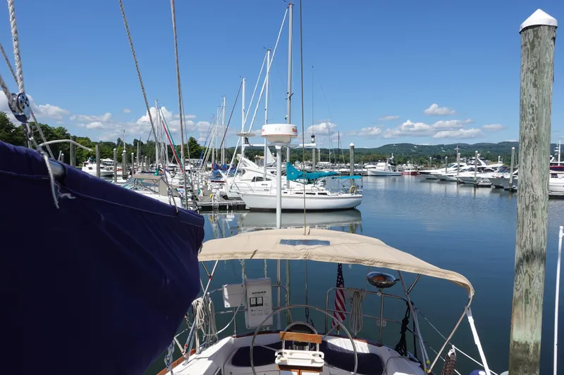 Slide: The Image of 1987 Tartan Marine 40 sailboat docked in a scenic marina under a clear blue sky. - 15