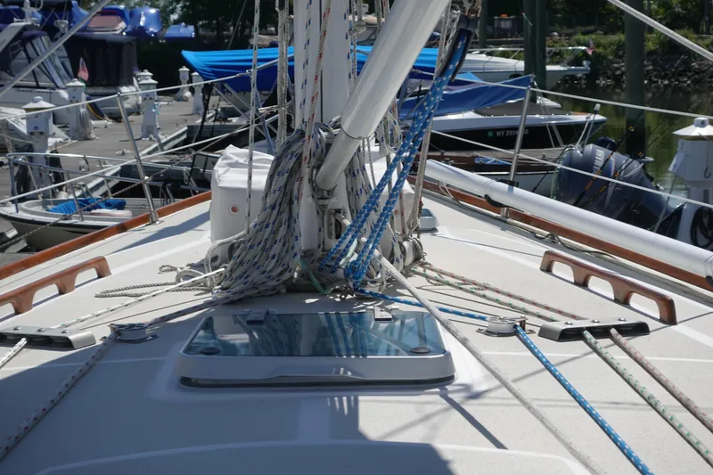Slide: The Image of 1987 Tartan Marine 40 sailboat deck with rigging and ropes in a marina. - 21