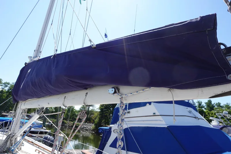 Slide: The Image of 1987 Tartan Marine 40 sailboat with covered mainsail, docked under clear blue sky. - 22