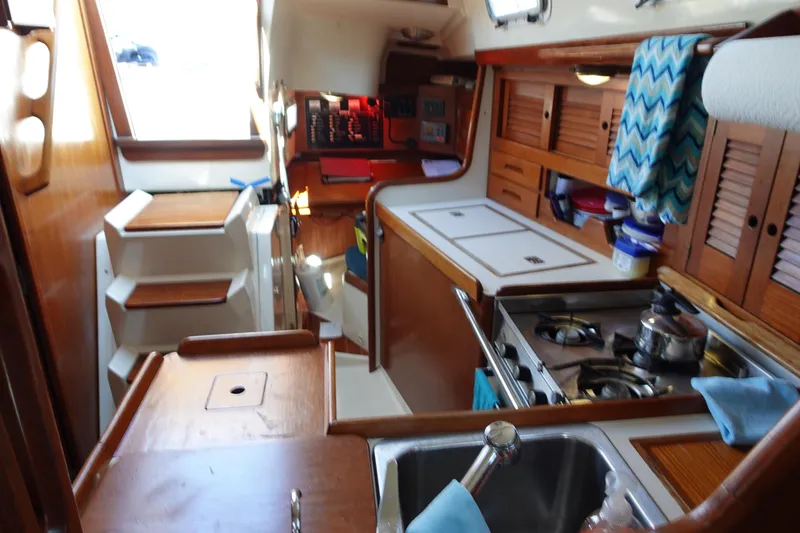 Slide: The Image of Interior of 1987 Tartan Marine 40 sailboat with kitchen and wooden cabinetry. - 24
