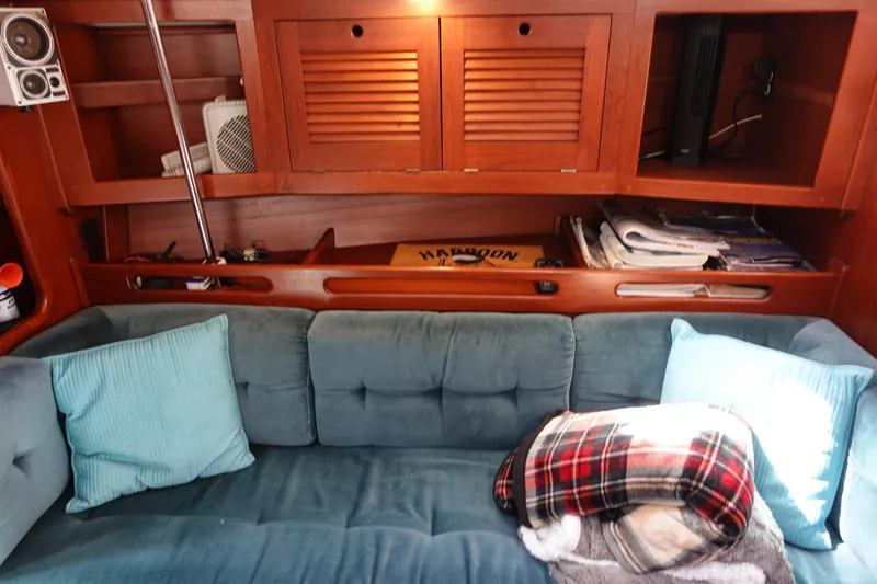 Slide: The Image of Cozy interior of 1987 Tartan Marine 40 yacht with blue sofa and wooden cabinetry. - 31