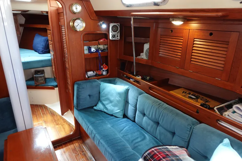 Slide: The Image of Interior of 1987 Tartan Marine 40 sailboat with cozy seating and wooden cabinetry. - 32