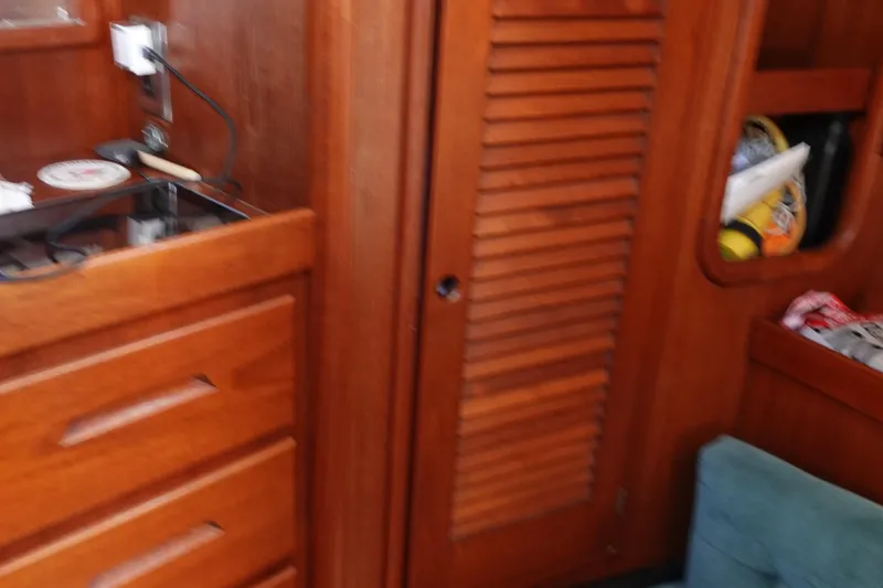 Slide: The Image of Interior of 1987 Tartan Marine 40 sailboat with wooden cabinetry and storage. - 37