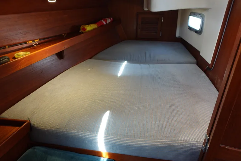 Slide: The Image of Cozy cabin interior of 1987 Tartan Marine 40 sailboat with comfortable bedding. - 38