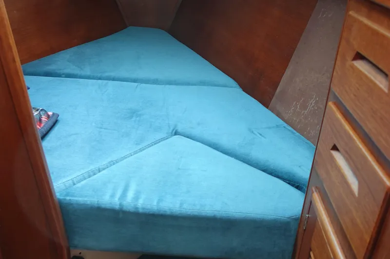 Slide: The Image of Cozy cabin interior of 1987 Tartan Marine 40 sailboat with blue cushions. - 39