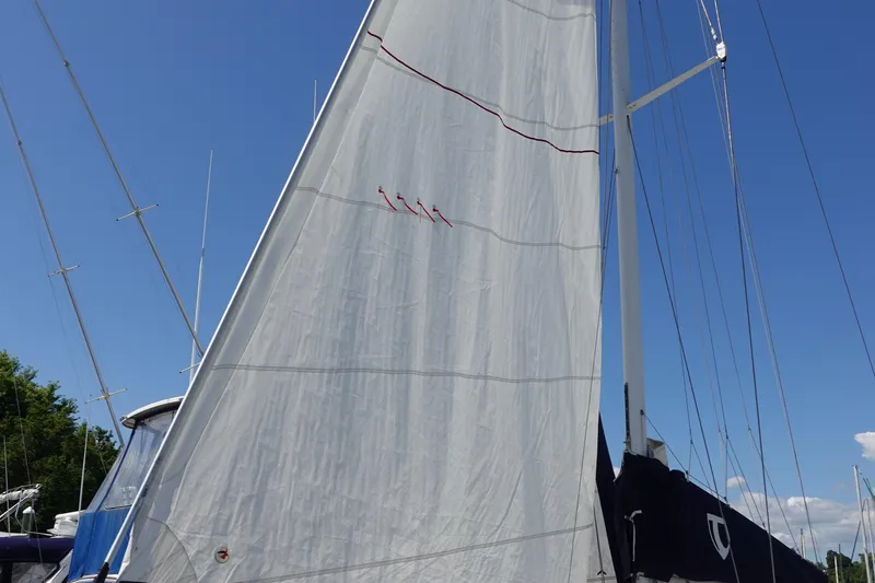 Slide: The Image of Sailboat with white sail against blue sky, Tartan Marine 40, 1987 model. - 4