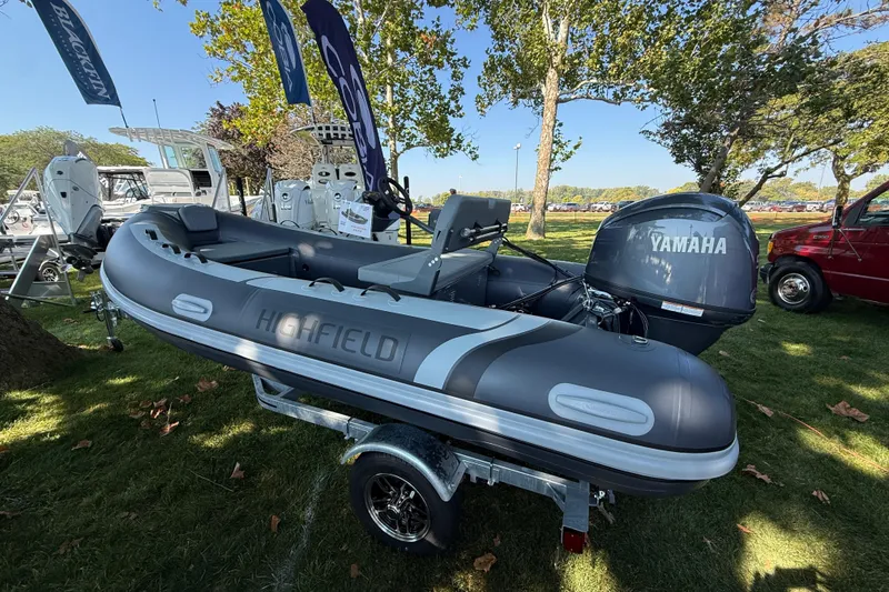 The Image of 2025 Highfield Classic 400 inflatable boat with Yamaha engine on display outdoors. - 1