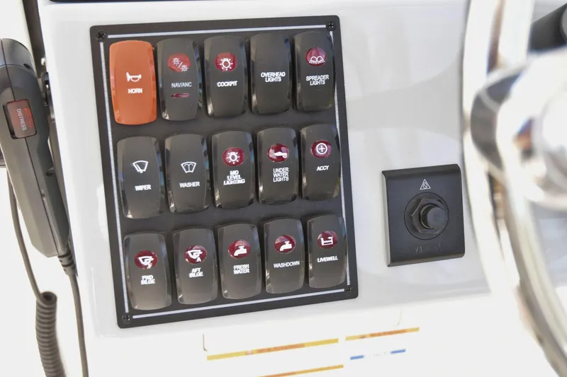 Slide: The Image of Control panel of 2024 Pursuit DC 246 Dual Console boat with labeled switches. - 11