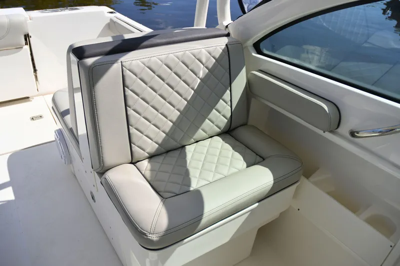 Slide: The Image of 2024 Pursuit DC 246 Dual Console boat seat with quilted upholstery. - 12