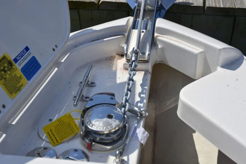Slide: The Image of 2024 Pursuit DC 246 Dual Console anchor chain and winch detail. - 15