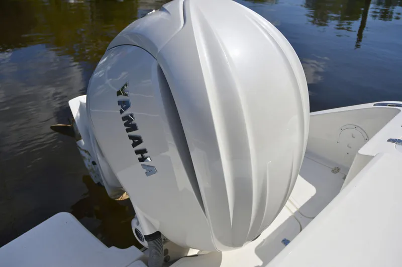 Slide: The Image of 2024 Pursuit DC 246 Dual Console with Yamaha outboard engine on water. - 3