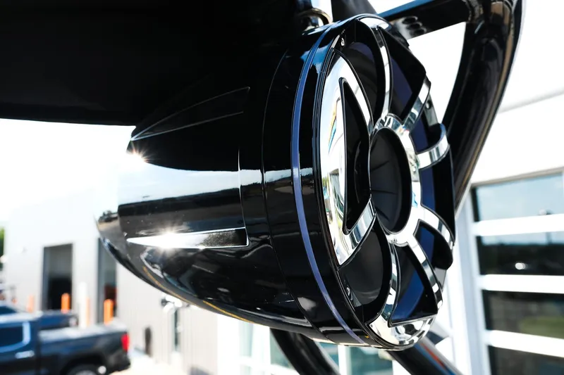 Slide: The Image of 2024 Moomba Tykon boat speaker, sleek black and chrome design, outdoor setting. - 14