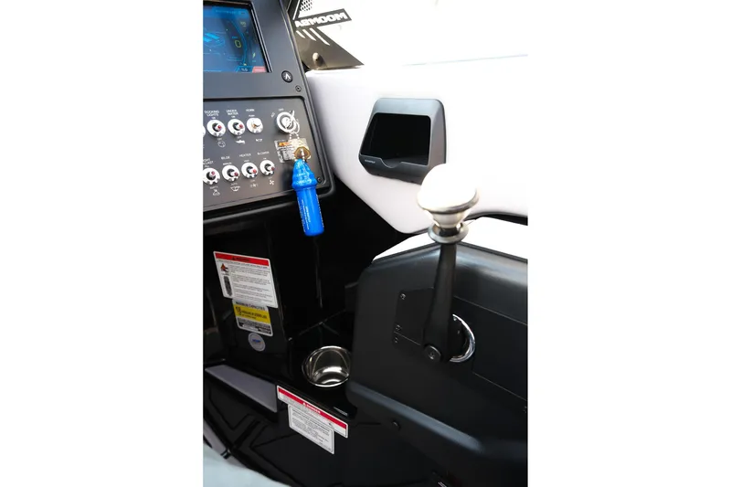Slide: The Image of 2024 Moomba Tykon boat dashboard with control panel and gear lever. - 19