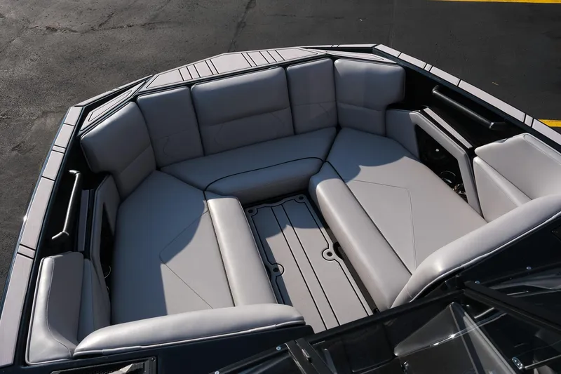 Slide: The Image of 2024 Moomba Tykon boat interior with spacious, cushioned seating in a sleek design. - 23