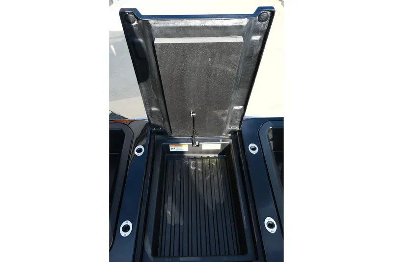 Slide: The Image of 2024 Moomba Tykon storage compartment with open lid, showcasing interior design and functionality. - 31