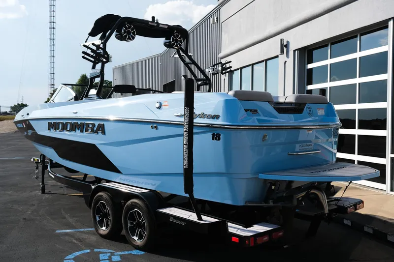 Slide: The Image of 2024 Moomba Tykon boat in blue, parked on a trailer outside a modern building. - 4