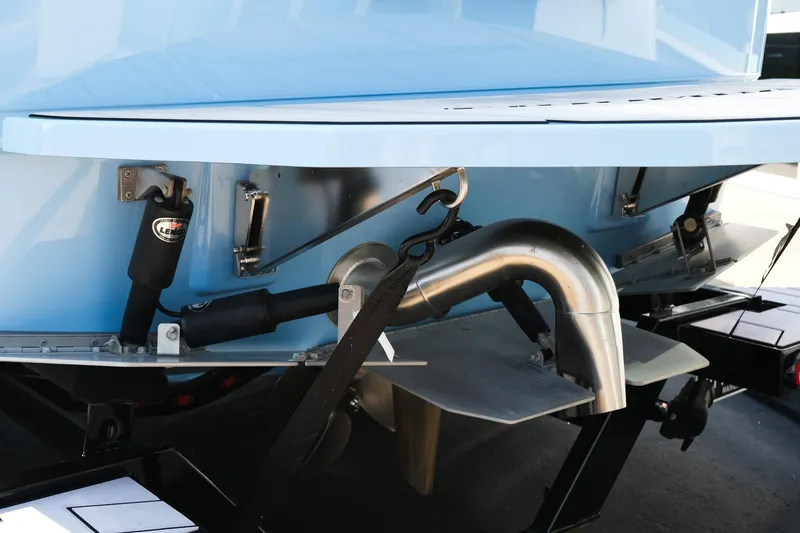 Slide: The Image of 2024 Moomba Tykon boat stern with exhaust and trim tabs, close-up view. - 5