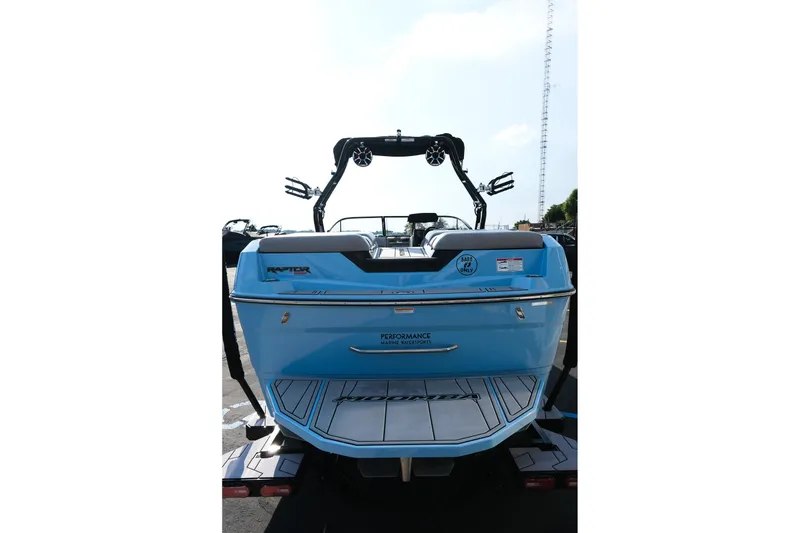 Slide: The Image of 2024 Moomba Tykon boat, rear view, blue color, featuring Raptor engine and wakeboard tower. - 6