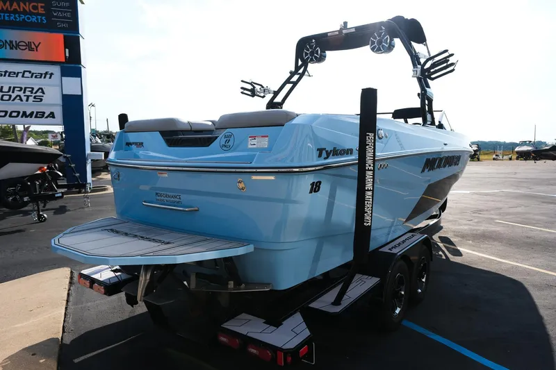 Slide: The Image of 2024 Moomba Tykon boat in blue, displayed at a marine dealership. - 7