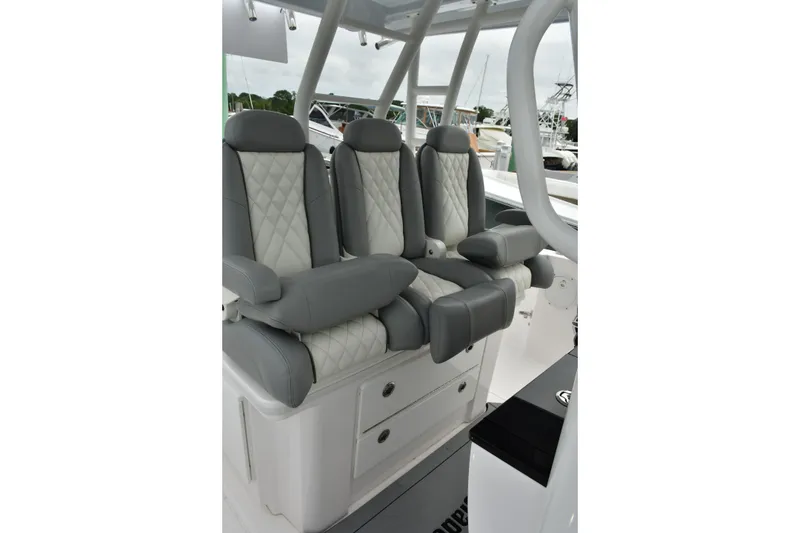 Slide: The Image of Luxurious seating on 2022 Everglades 335 Center Console boat, featuring quilted upholstery. - 11
