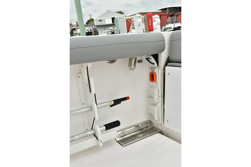 Slide: The Image of 2022 Everglades 335 Center Console interior detail with rod holders and power outlets. - 14